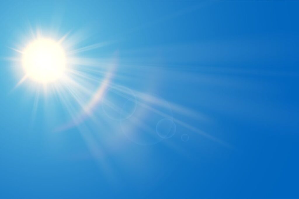 Bright sunny sky with radiant sunlight and lens flares.