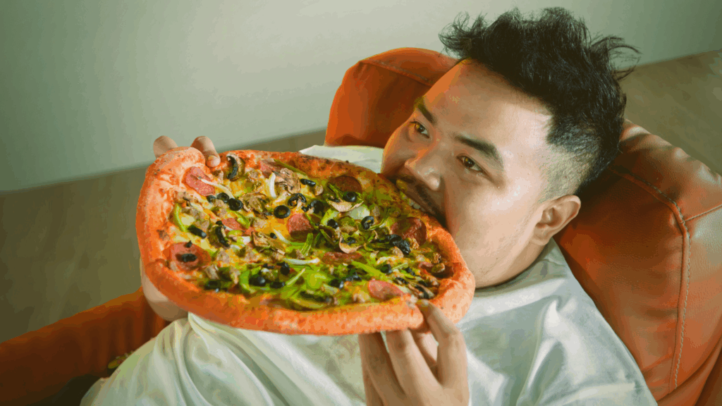 Overweight person eating pizza.