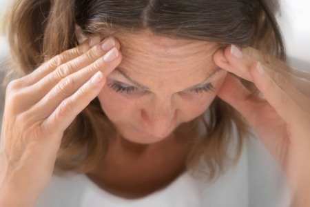 Back view of a man with visible thinning hair on the crown, with a close-up illustration showing hair follicles beneath the scalp
