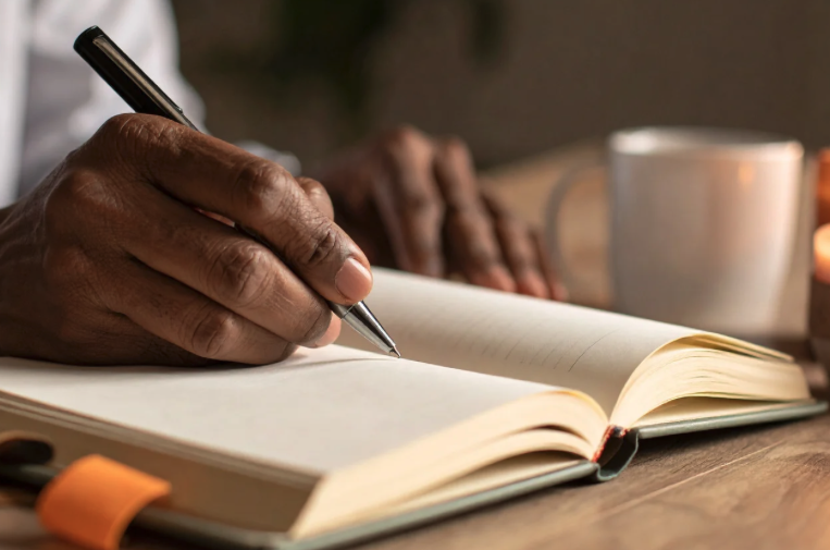 Writing daily thoughts in a notebook